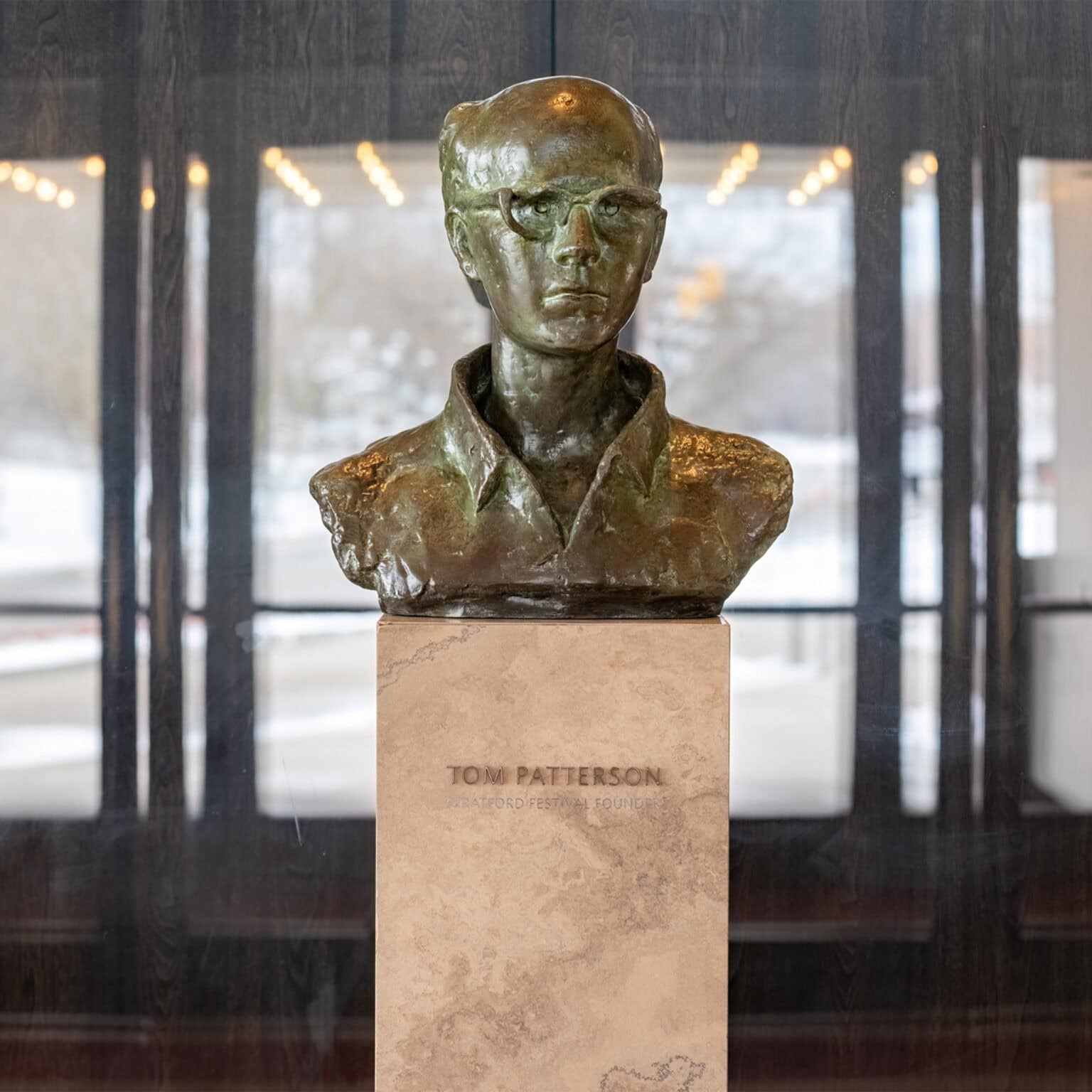 Bust of Tom Patterson with bronze dimensional identififcation lettering.