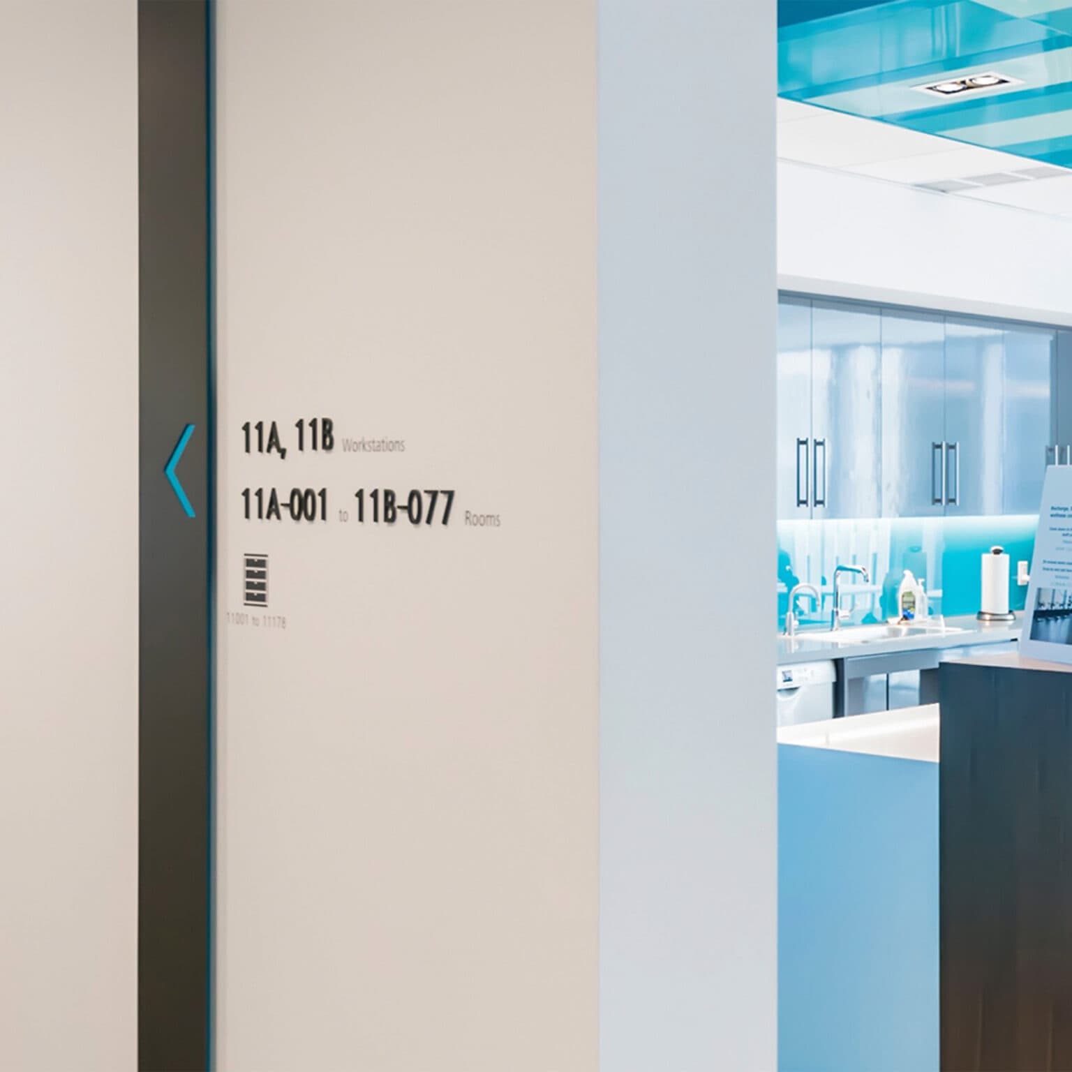 Deloitte corridor featuring directional, dimenstional wayfihding signage