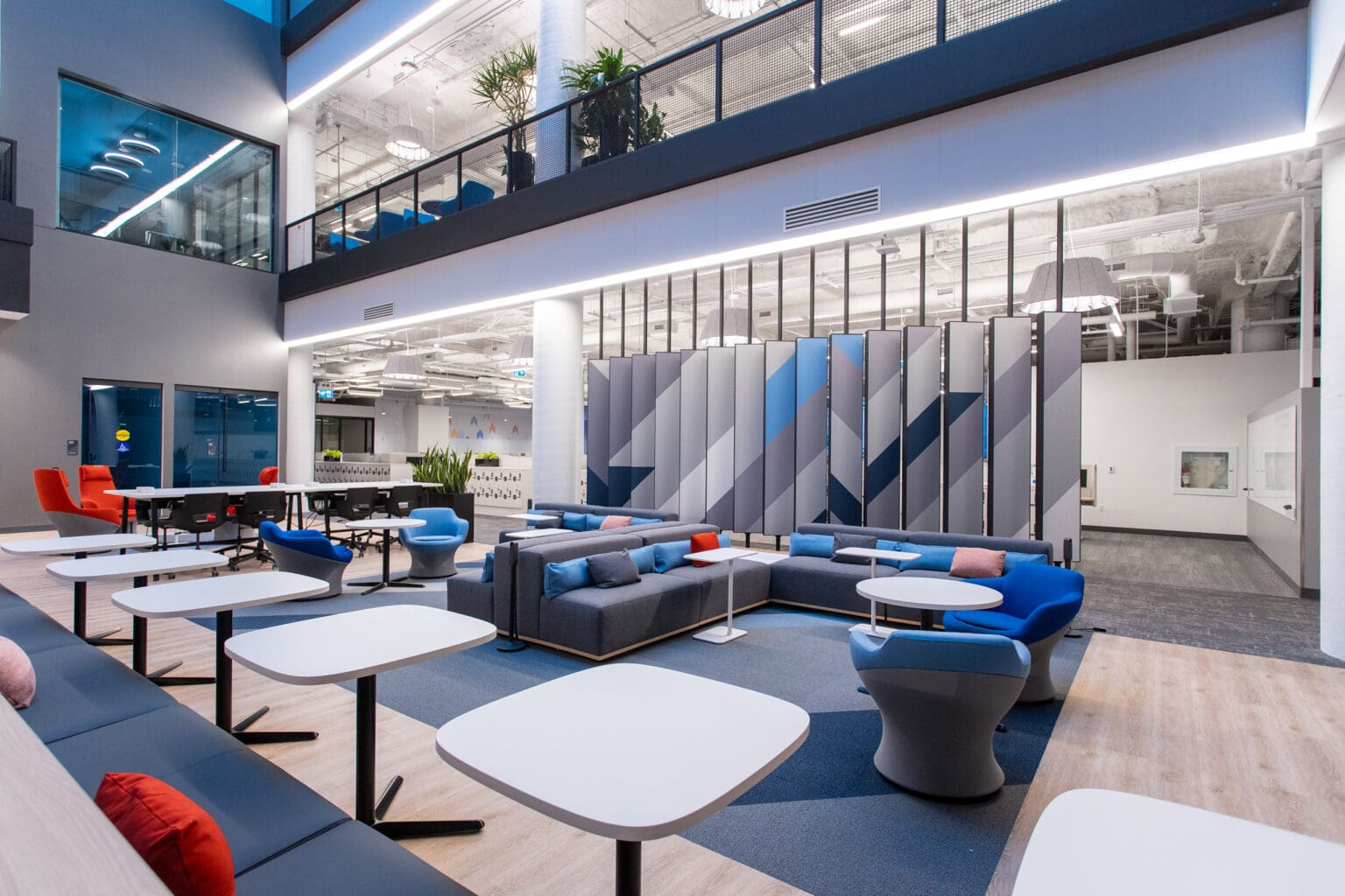 BMO Place lounge/lobby areas showing decorative panel installation and colour scheme of blue and grey with bright accents.