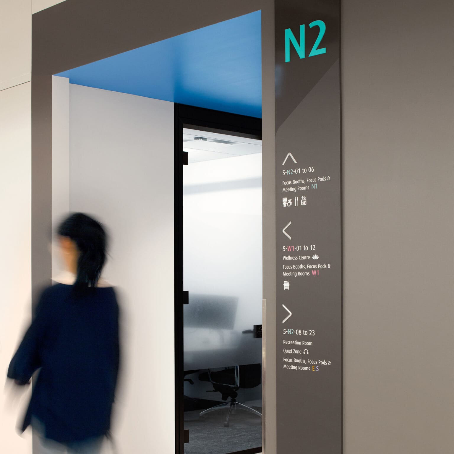 Plank wayfinding signage mounted on the wall.