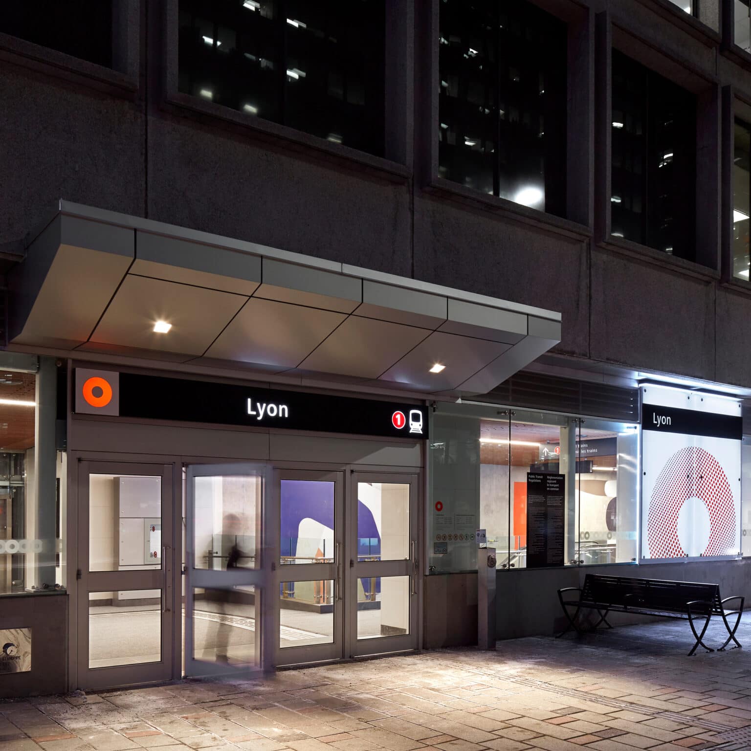 OC Transpo's Lyon Station at night, with illuminated station identifier and branding.