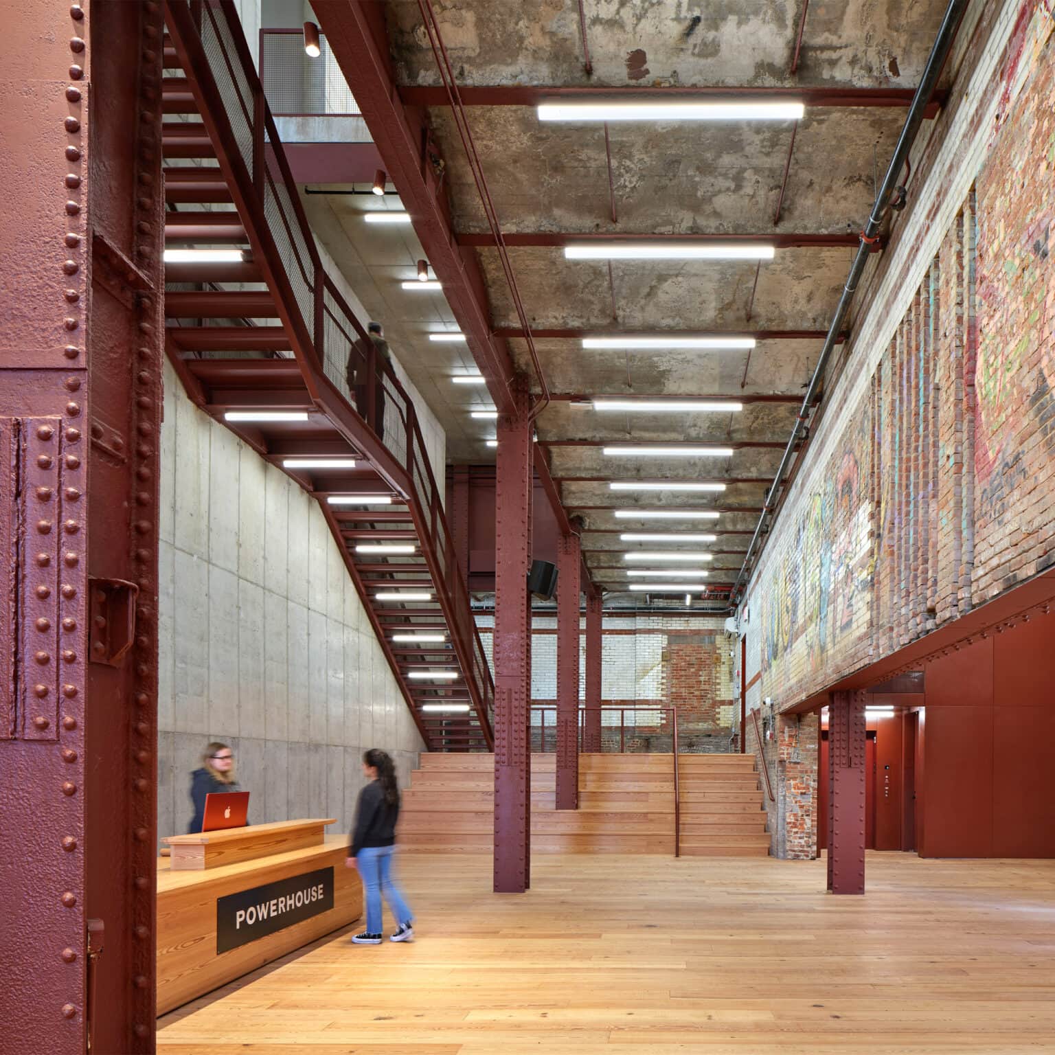 Reception area inside powerhouse, with desk and walls covered with graffiti.