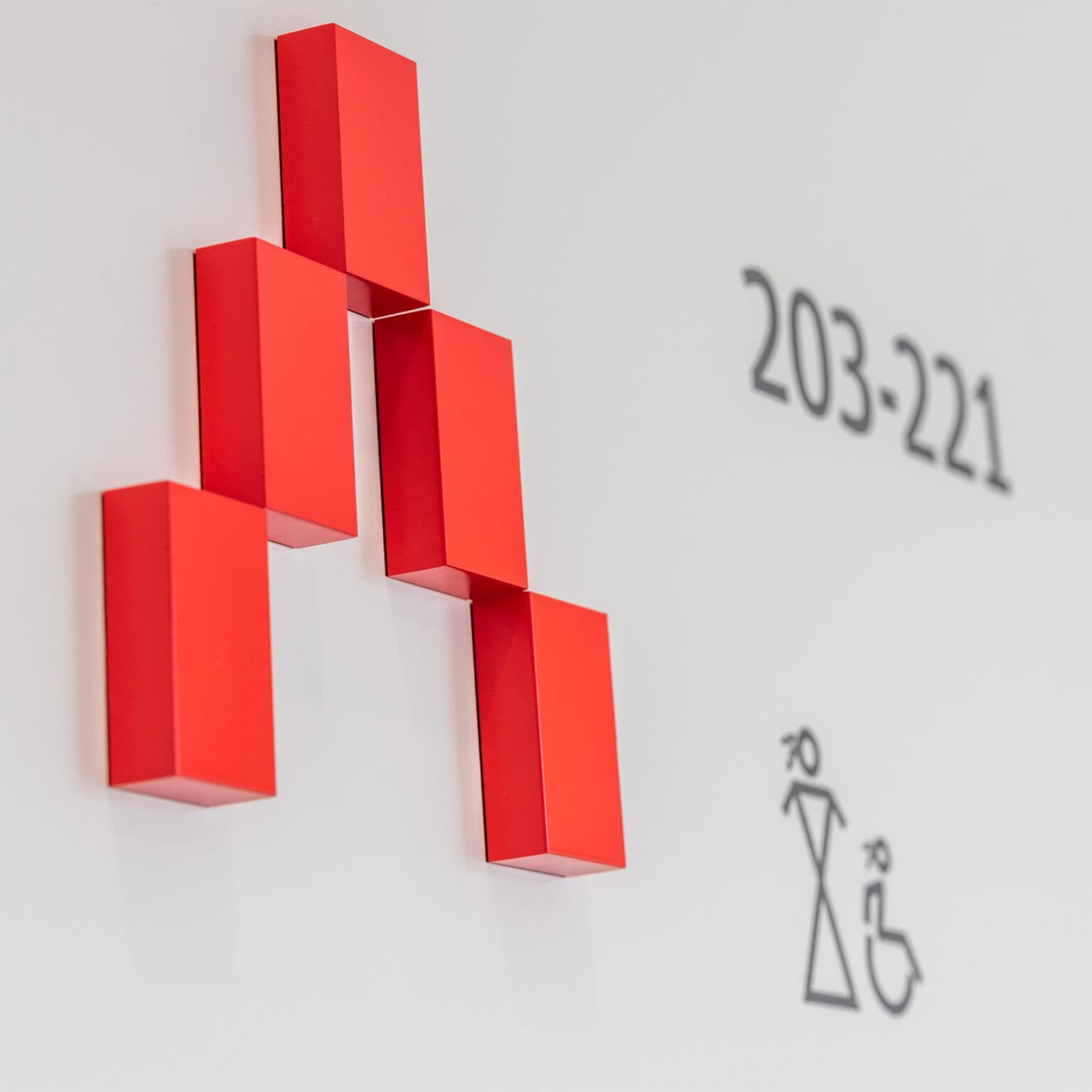 Detail of directional signage showing dimensional arrow.