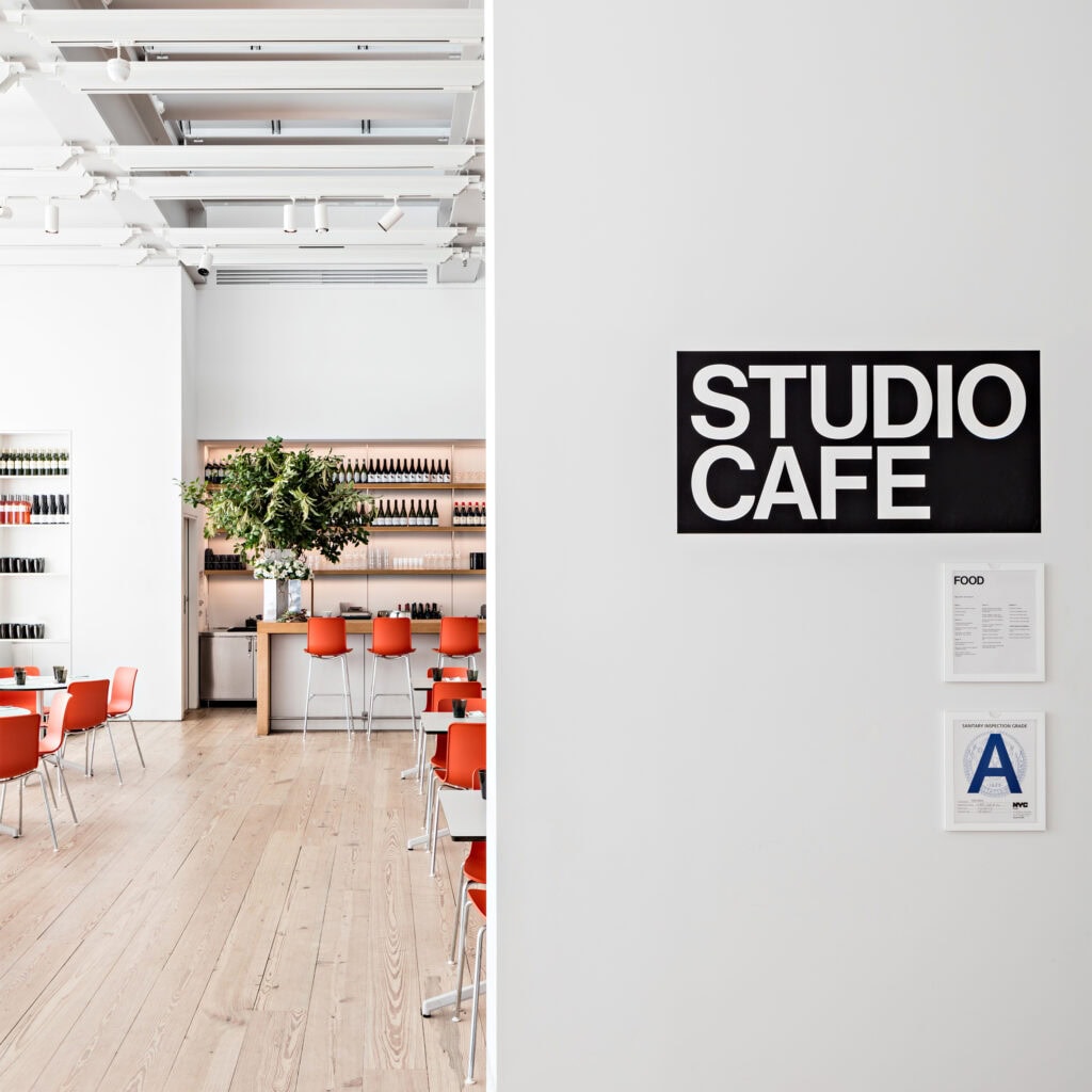 Minimal 'Studio Cafe' sign in vinyl, adhered to a wall outside the Whitney's studio cafe.