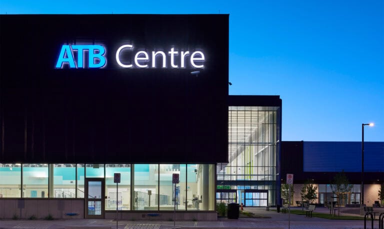 ATB Centre exterior at dusk, featuring large "ATB Centre" illuminated sign on building facade