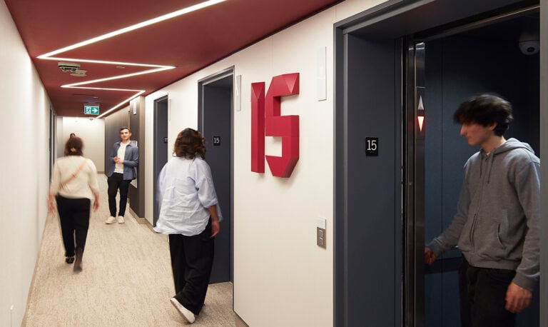 McMaster University 10 Bay Student Residence residential elevator lobby featuring dimensional floor number in maroon.