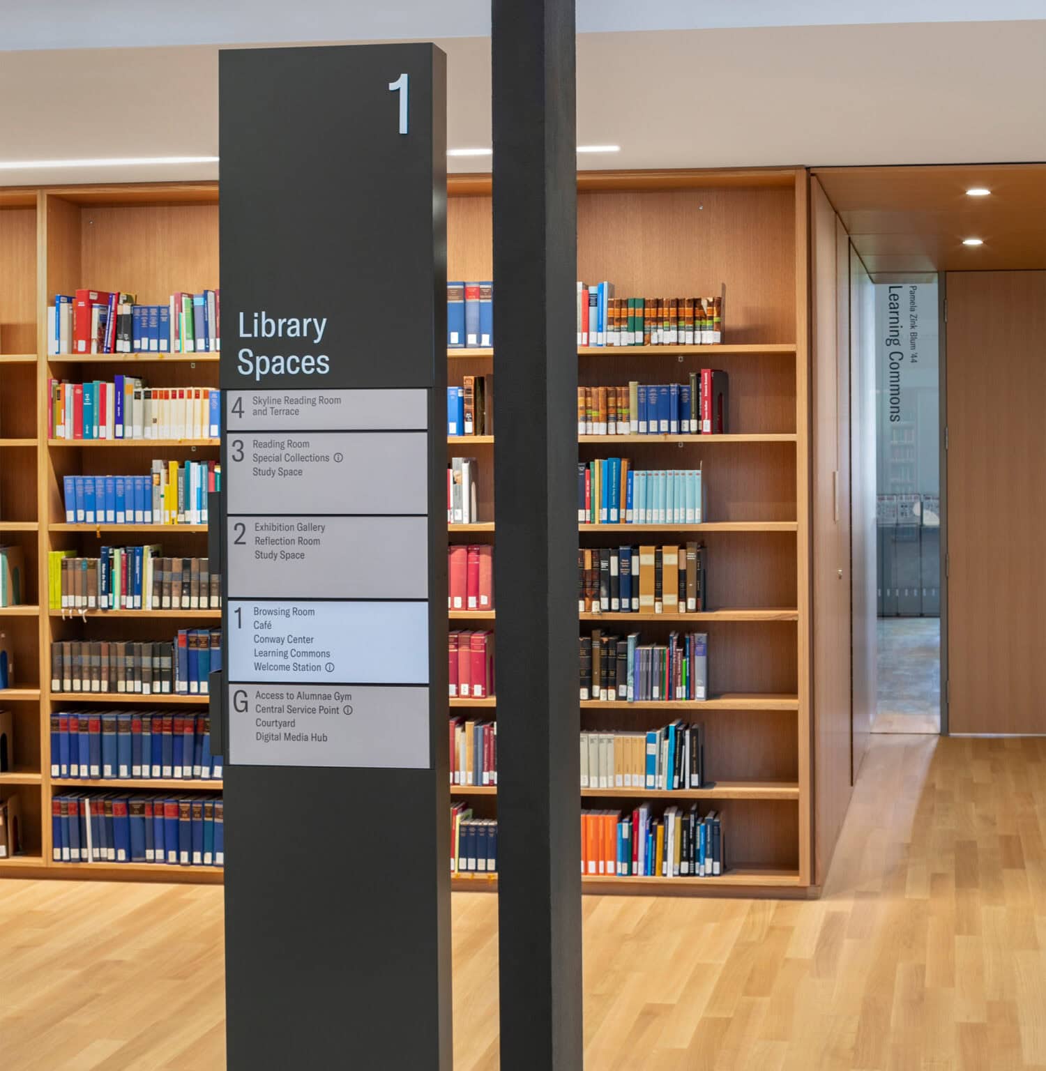 Neilson Library freestanding pylon directory in warm tones, with simple typography