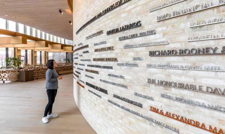 Tom Patterson Theatre interior curved donor wall with dimensional letters in bronze, gold and silver colors