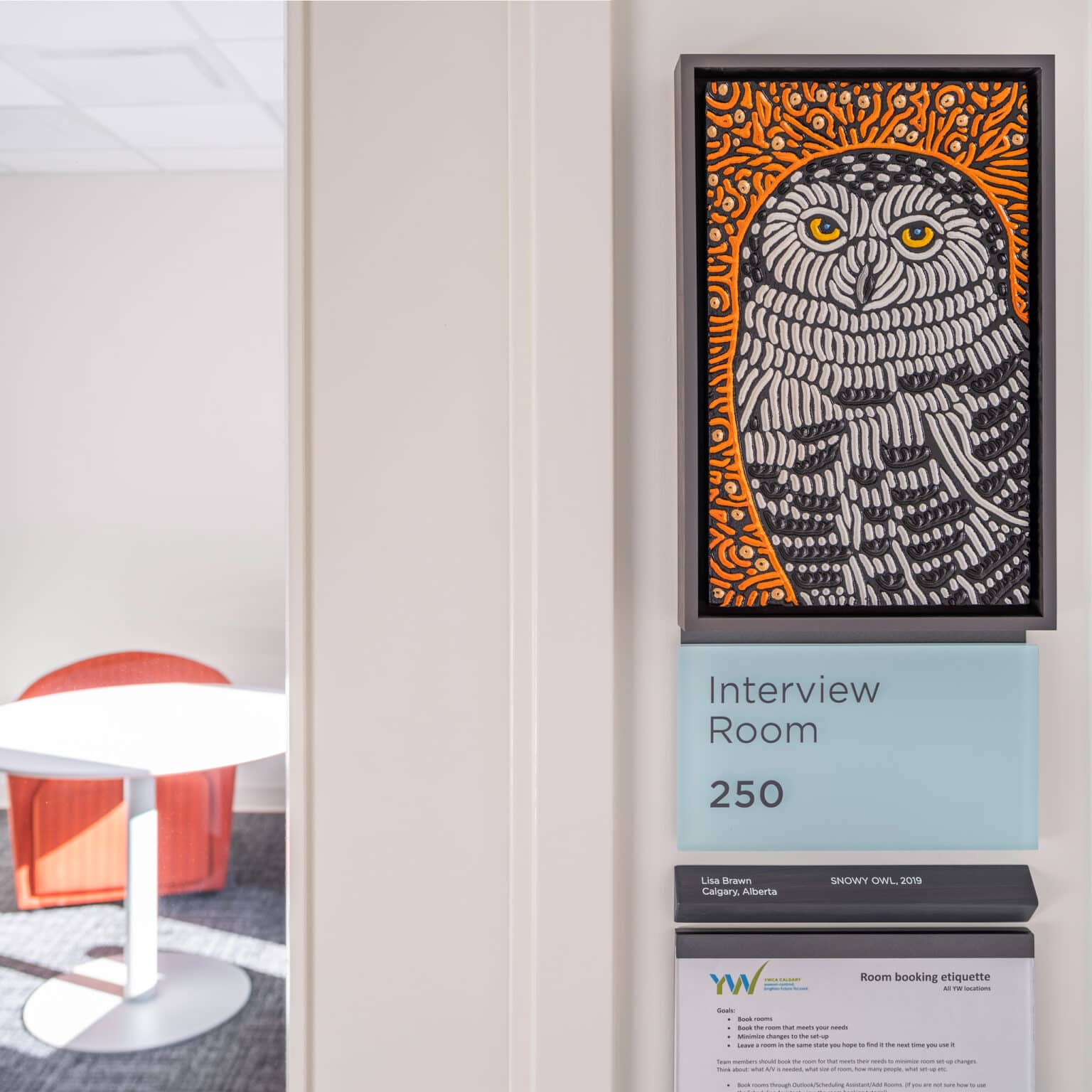 Artwork depicting owl mounted to a room sign. Artist Credit: Lisa Brawn, Snowy Owl, 2019.