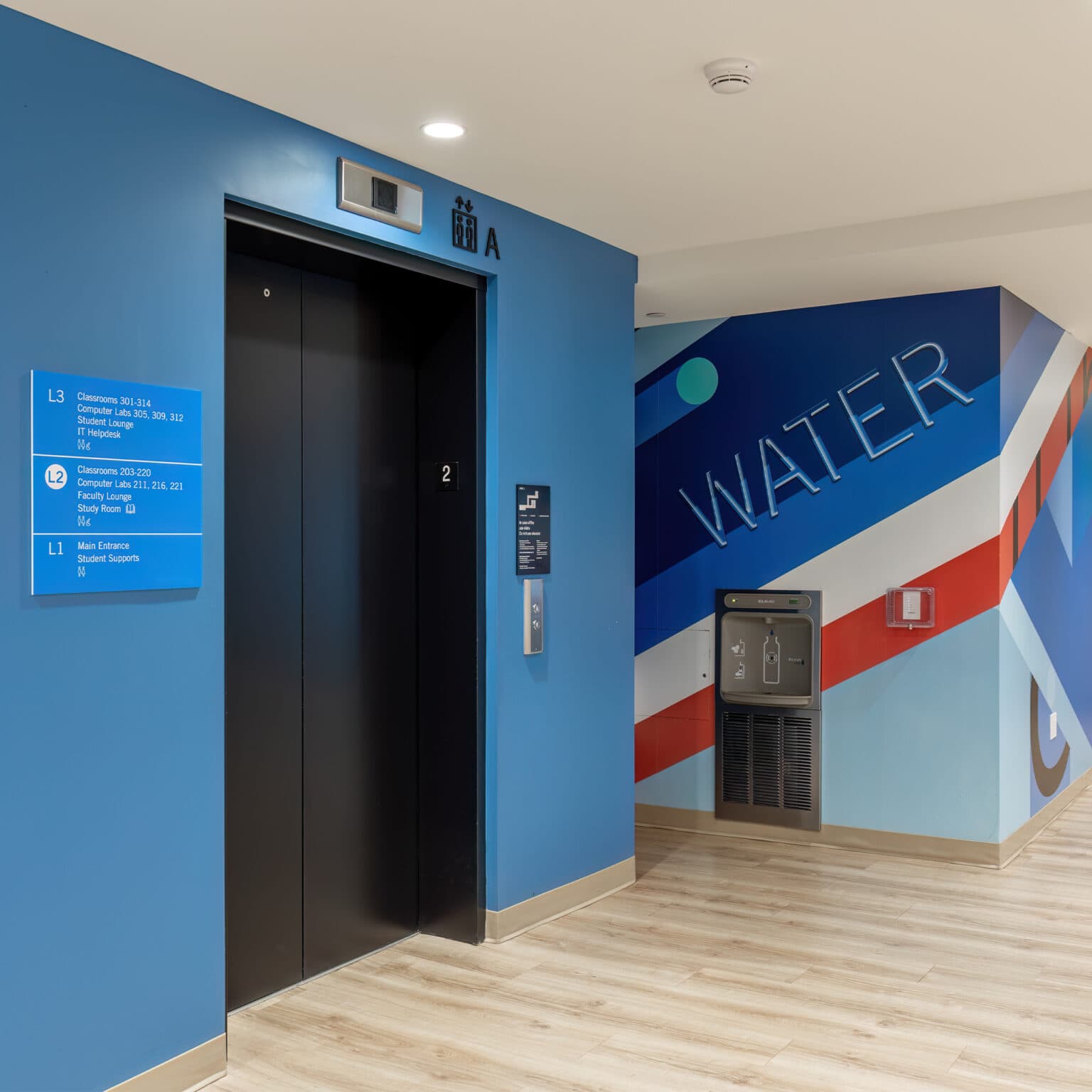 Niagara College – Toronto interior corridor featuring large scale graphics for water staation and elevator directory.