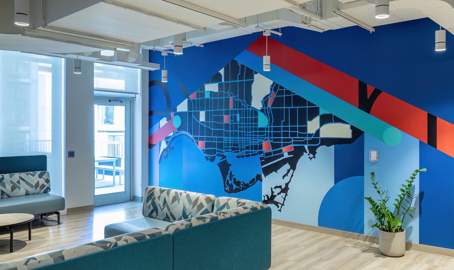 Niagara College – Toronto interior lounge space with large-scale mural depicting abstract map of Toronto.